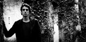 Photo of Psychedelic Indie Rock Music Artist Samuel Christen, half body photo with background ruins